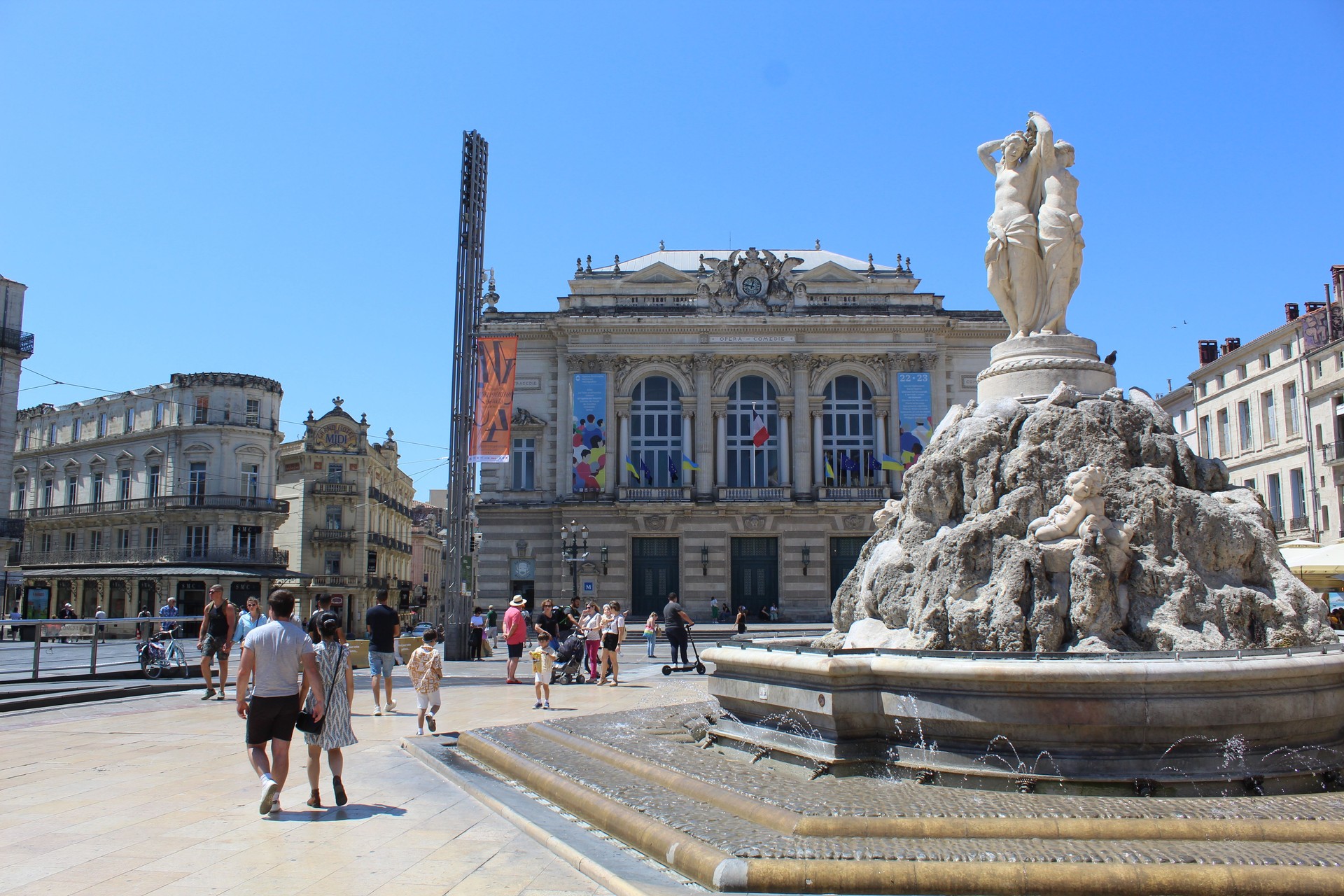 Traditional French architecture and fountain in La Place de la Comédie of Montpellier, France